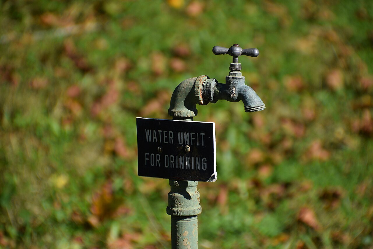 Outdoor tap with a sign reading water unfit for drinking